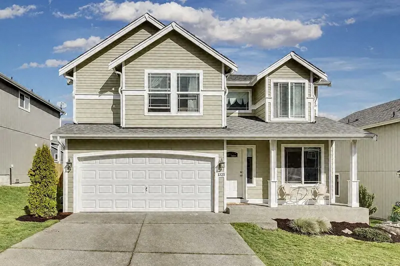 Two-story home with a freshly mowed front lawn and clean driveway edges